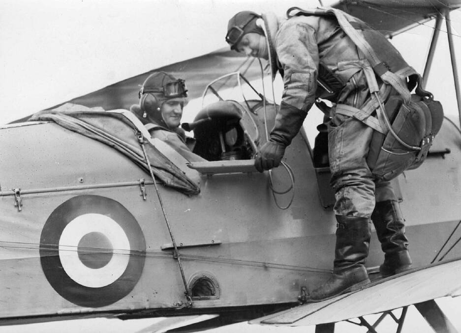 Trainee pilots next to one of the school's Tiger Moth aircraft. Picture by State Library of Victoria
