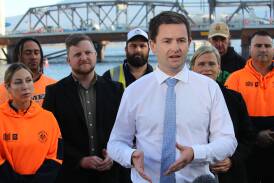 New Labor leader Dean Winter is photographed in front of construction workers in high-vis clothing. Picture supplied