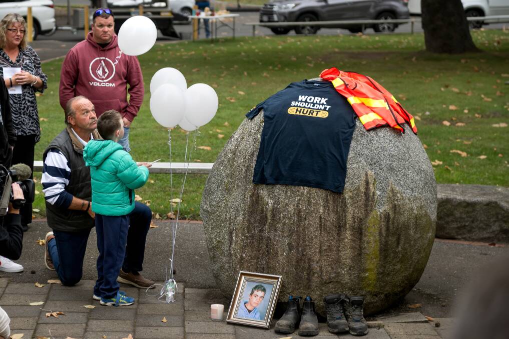 William Pugsley-Evans, age 6, helps Guy Hudson release a balloon at the Workers' Remembrance Day service at Elizabeth Gardens, Invermay. Guy's son Matthew was 16 when he was killed in a workplace accident. Picture by Phillip Biggs