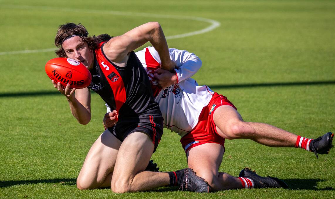 North Launceston's Brandon Leary shrugs a Clarence tackle. Picture by Paul Scambler