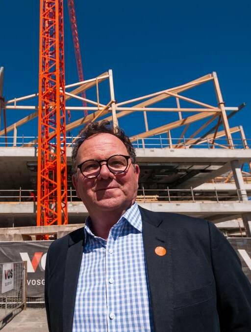 BUILDING UP: UTAS pro-vice-chancellor Dom Geraghty in front of the under-construction library and student experience building at Inveresk. Picture: Phillip Biggs