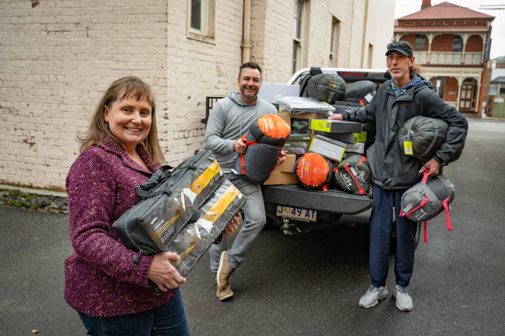 Shekinah House's Louise Cowan with sleeping bags, tents and mattresses that Gary Davenport of Launceston has donated, with supporter Rick Marton (left of picture). Picture by Paul Scambler