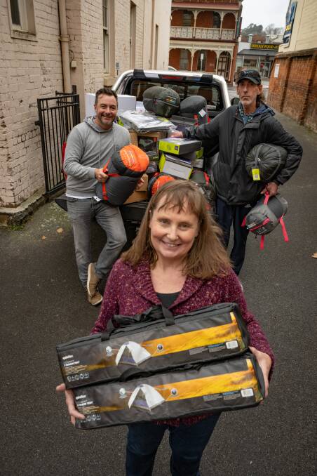 Shekinah House's Louise Cowan with sleeping bags, tents and mattresses that Gary Davenport of Launceston, has donated. with supporter Rick Marton (left of picture). Picture by Paul Scambler