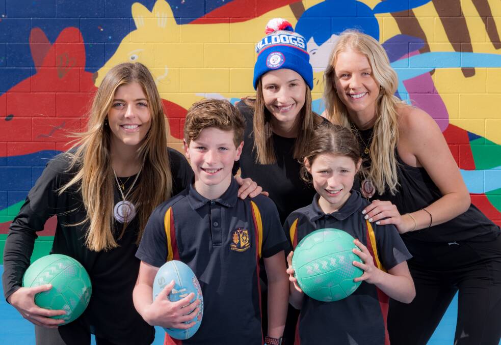 FIREBIRDS: Netballers Lara Dunkley, Kim Ravaillion and Rudi Ellis with Scotch Oakburn College students Flynn McLoughlin and Florence Rogers. Picture: Phillip Biggs