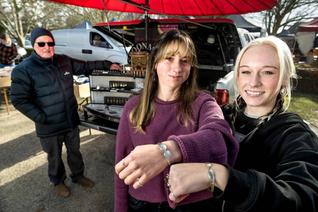 Nykara Simpson (centre) and Luci Artini were happy customers after visiting Mr Burrows' stall at Evandale Market. Picture by Phillip Biggs