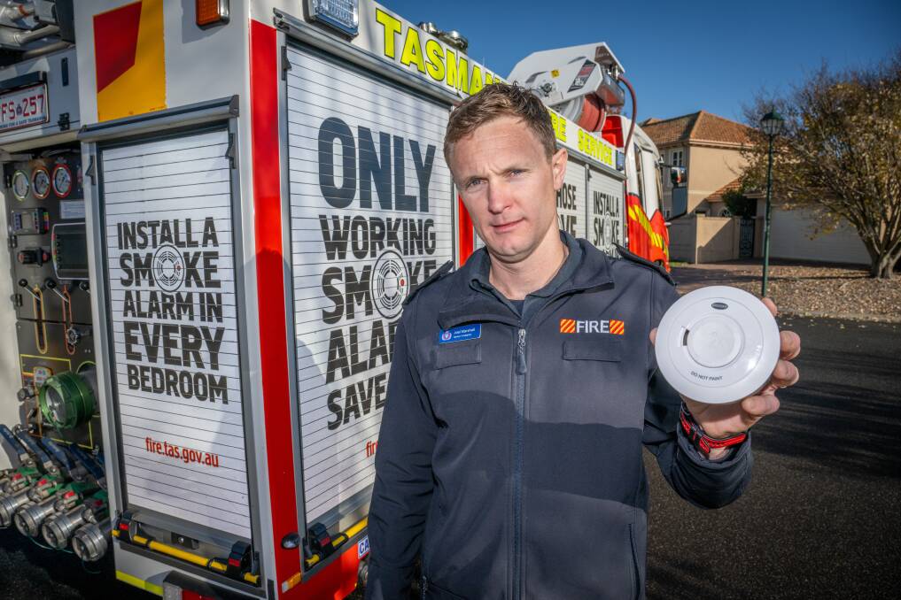 Senior firefighter Joel Marshall with a smoke alarm as the Tasmania Fire Service launches its winter home fire safety campaign. Picture by Paul Scambler