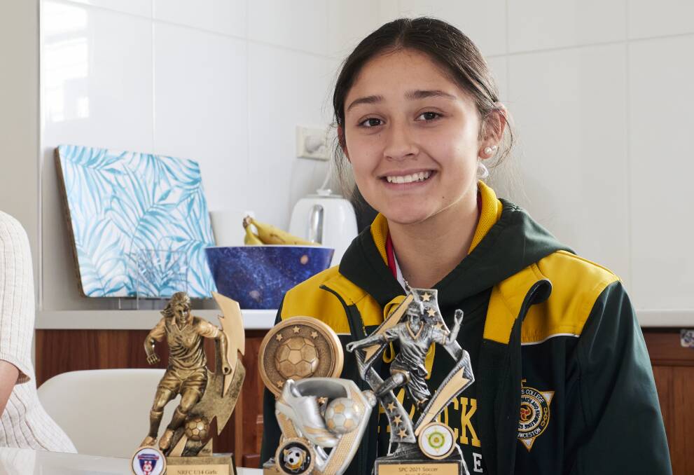 Maria Penuela Castillo (14) posing with a number of soccer trophies. Picture by Rod Thompson.
