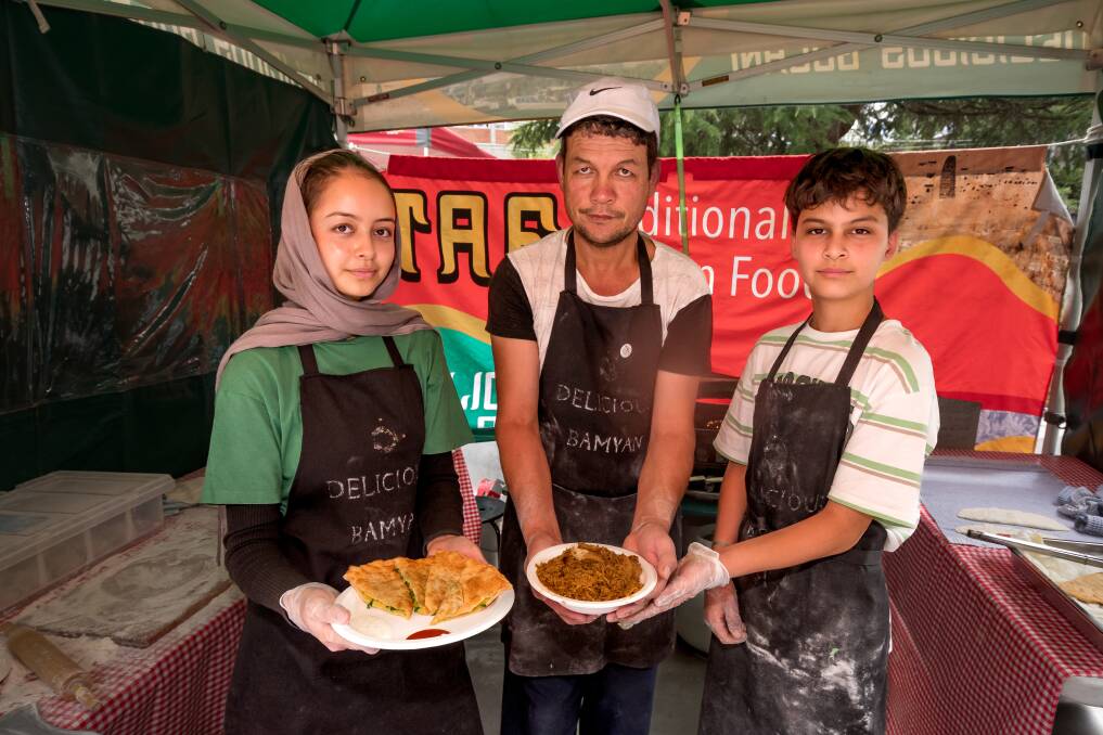 Zeynab Jafari, Gholim Jafari and Amir Jafari in their Traditional Afgan Food tent kitchen at World Street East festival in Civic Square. Picture by Phillip Biggs