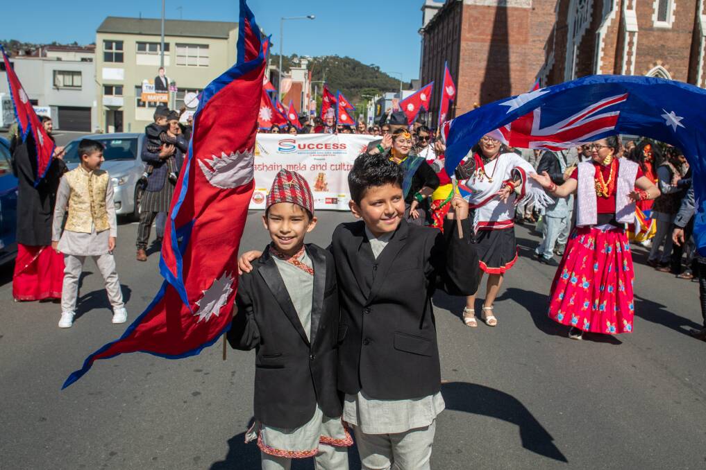 Adarsh Pathak, 9, and Rthym Dahal, 10, in front of the parade in Paterson Street, Launceston at the Nepalese Cultural Parade & Dashain. Picture by Paul Scambler