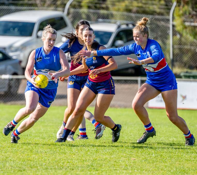 South Launceston's Hannah Viney kicks while Jaslyn Freestone shepherds during their team's first match against Old Scotch. Picture by Paul Scambler