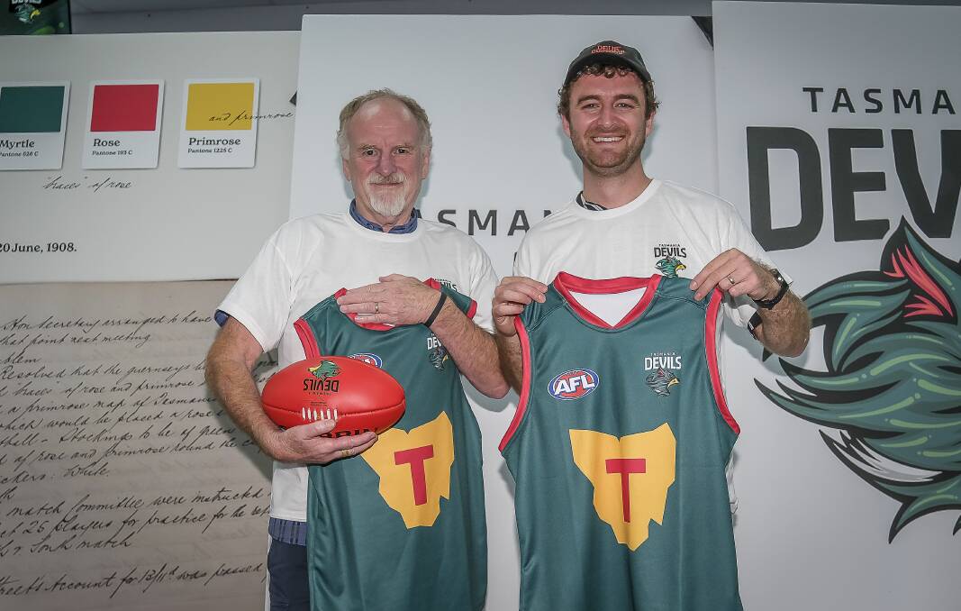 Wayne and James Ballard, from Launceston, holding the Tasmania Devils foundation guernsey. Picture by Craig George