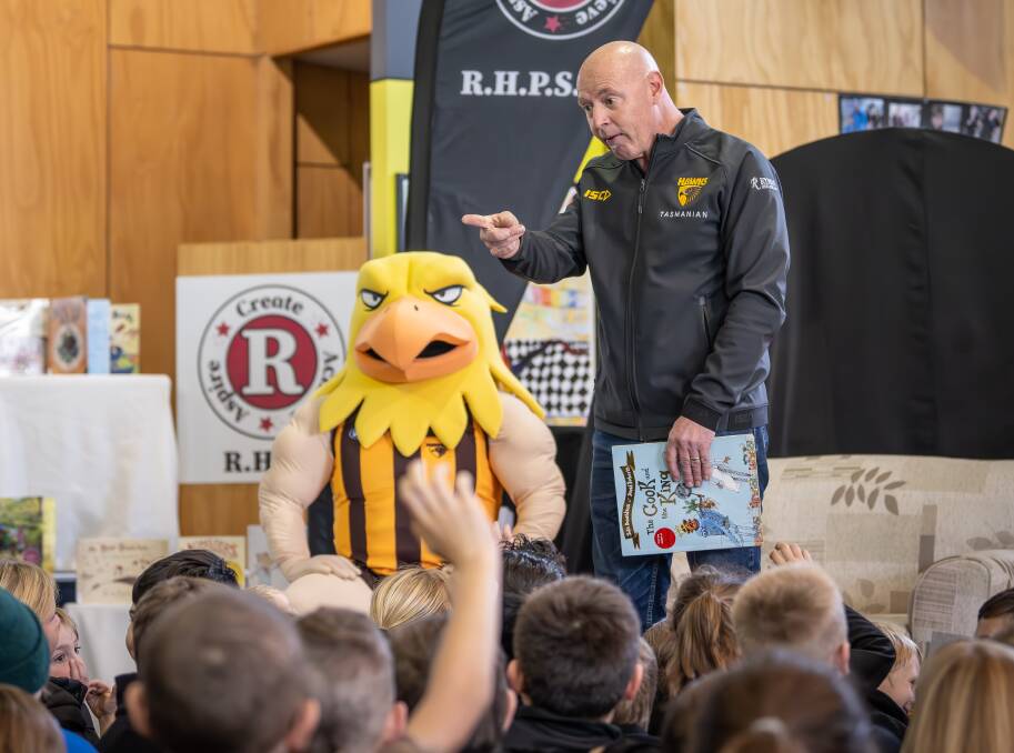 Hawthorn mascot 'Hawka' and head of football operations in Tasmania David Cox held a reading session at Ravenswood Heights Primary School. Pictures by Craig George