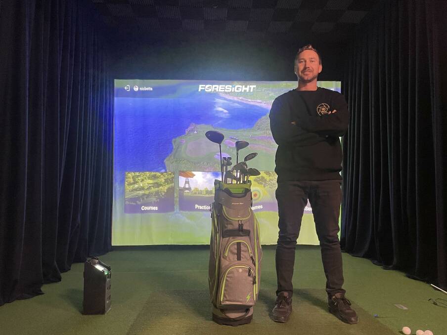 Owner of Bridport Golfers Lounge, Nic Betts, standing in front of his indoor golf simulator. Pictures by Ben Hann