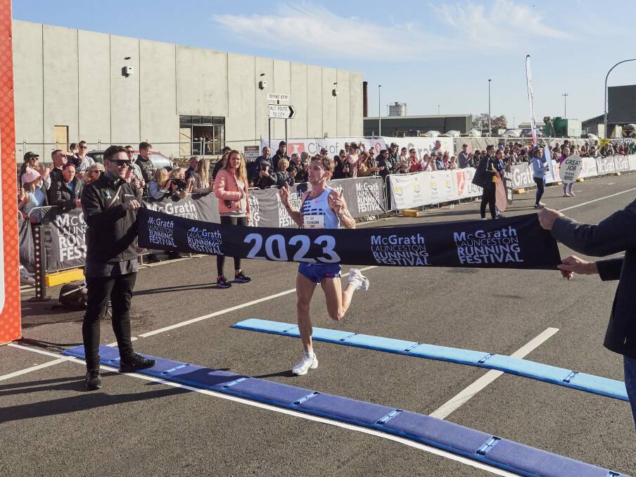 Brett Robinson crossing the finish line in record time.