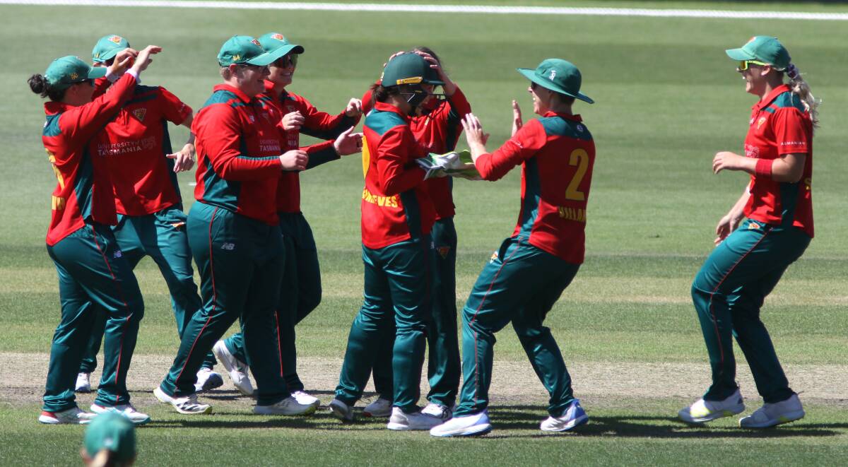 Tasmanian Tigers wicket-keeper Emma Manix-Geeves is congratulated by her teammates. Picture by Rick Smith