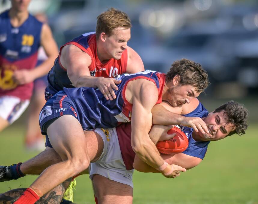 Lilydale's Jordan Russell and Tyson Watts tackle Old Scotch's Fletcher Seymour. Pictures by Craig George
