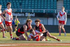 North Launceston's Harry Bayles and Beau Nash pounce on Clarence's Lachlan Borsboom at UTAS Stadium on Saturday. Pictures by Paul Scambler