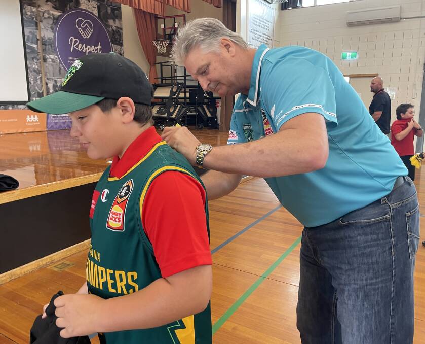 Scott Roth signs a JackJumpers shirt for Xavier Kelly at Summerdale Primary School. 