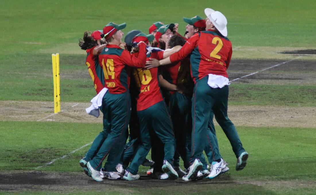The Tasmanian Tigers players celebrate victory in the WNCL final. Picture by Rick Smith