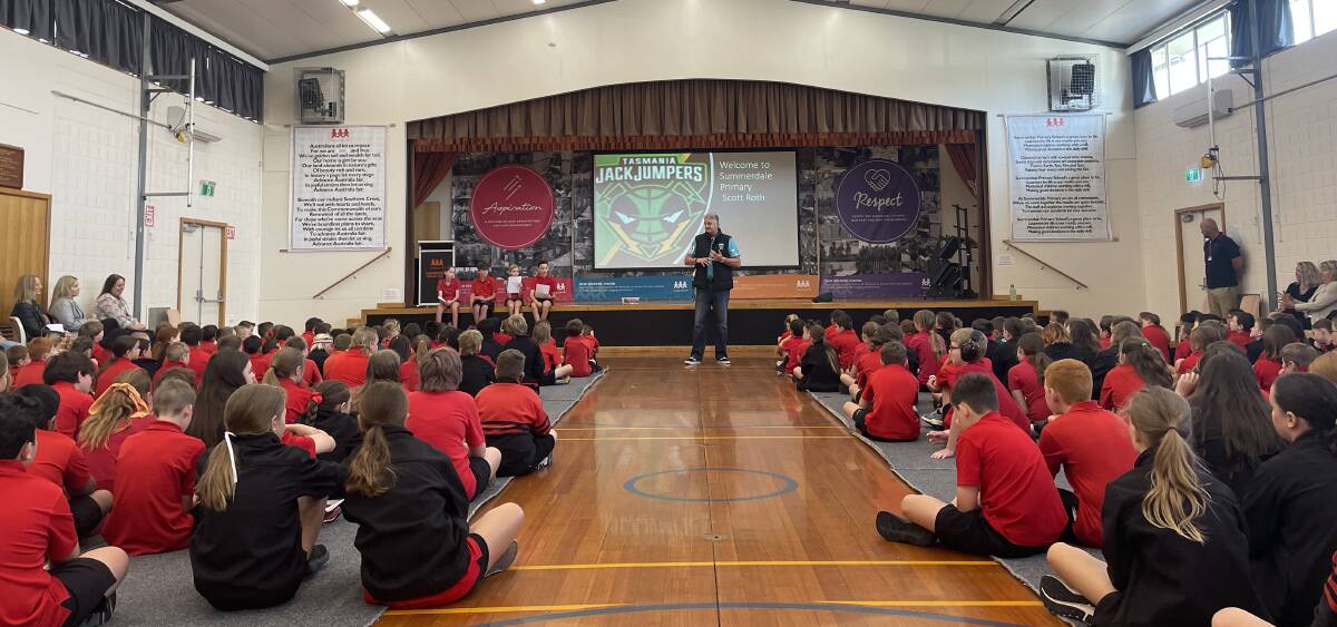 Tasmania JackJumpers coach Scott Roth talks to pupils at Summerdale Primary School on Monday.