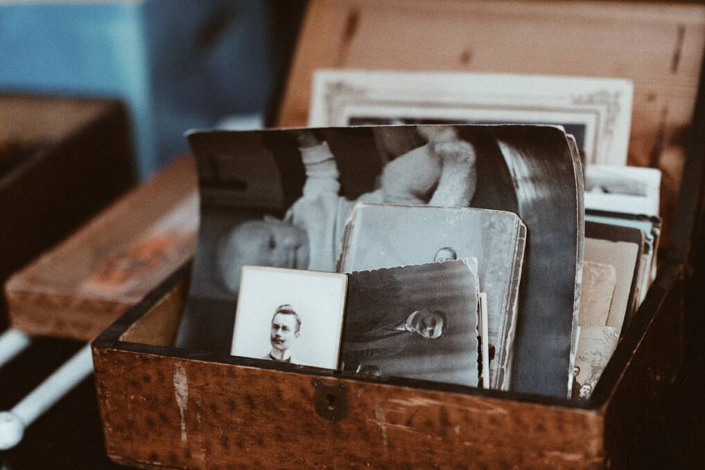 A collection of old photographs. Picture by Roman Kraft from Unsplash. 