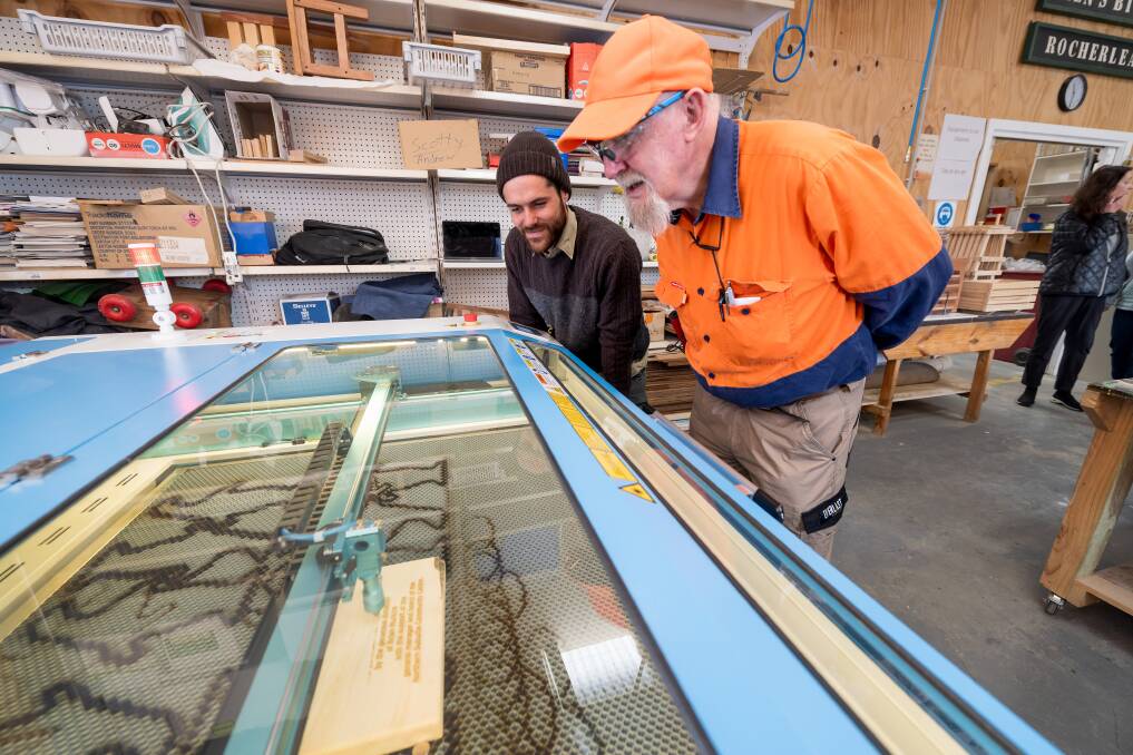 The Shed project officer Jay Dunn and supervisor Joe Double watch the laser cutter in action. Picture by Phillip Biggs