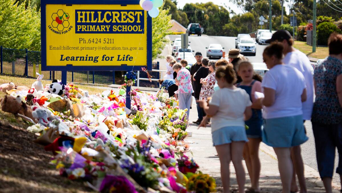 Flowers are laid outside the Hillcrest Primary School in the wake of the death of six children in a jumping castle tragedy.