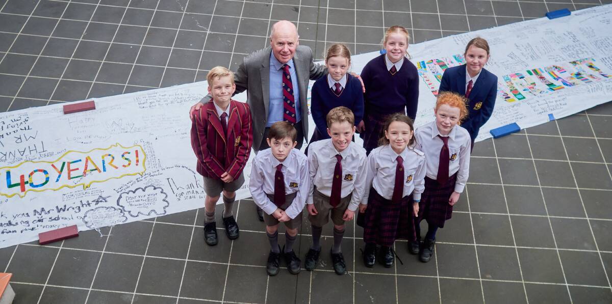 Retiring Scotch Oakburn College junior school principal Lachie Wright with year five students and a banner signed by the entire school to wish him farewell. Picture by Rod Thompson