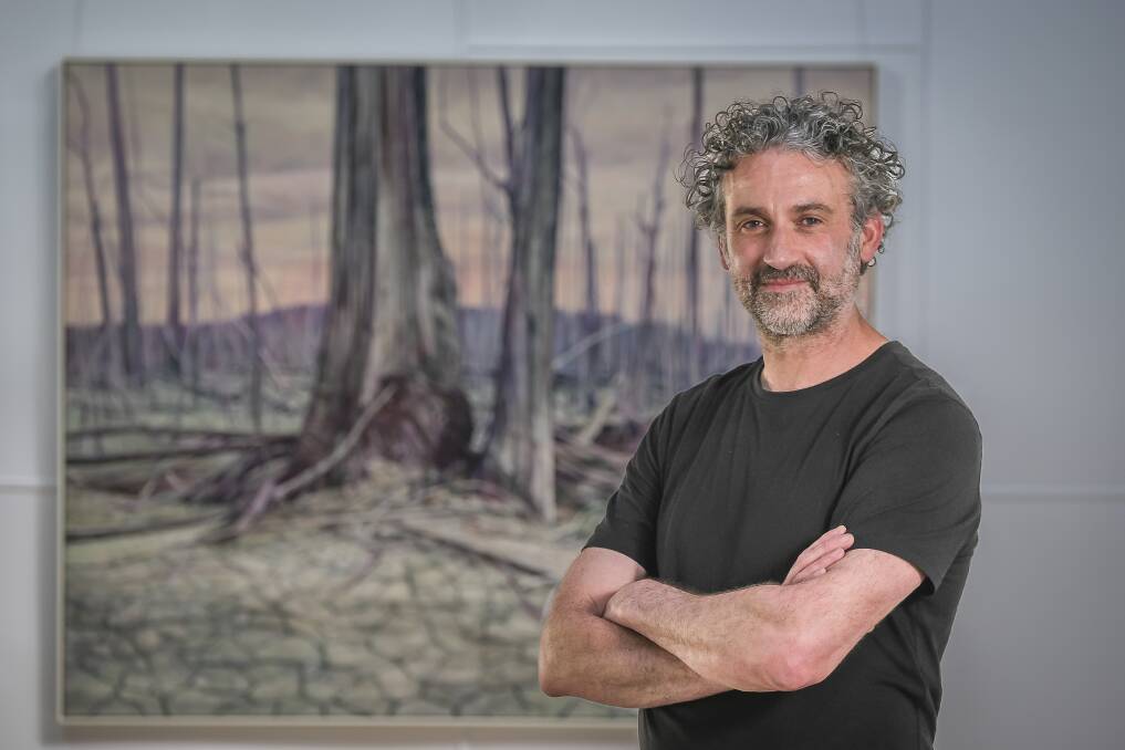 Glover Prize winner and Hobart artist Nicholas Blowers with his oil on canvas painting 'Lake Bed'. Picture by Craig George