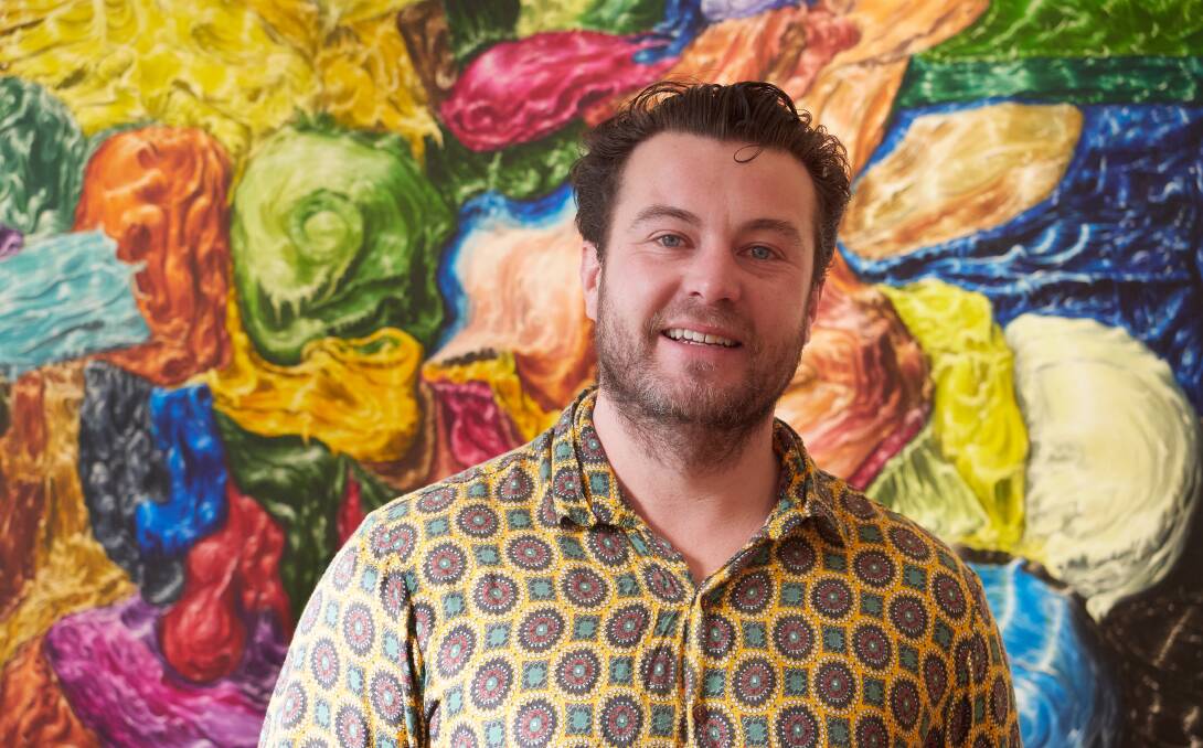 Josh Foley with his painting "Sarah Island circa 1843" at the LAG Exhibition at Poimena Gallery. Picture by Rod Thompson
