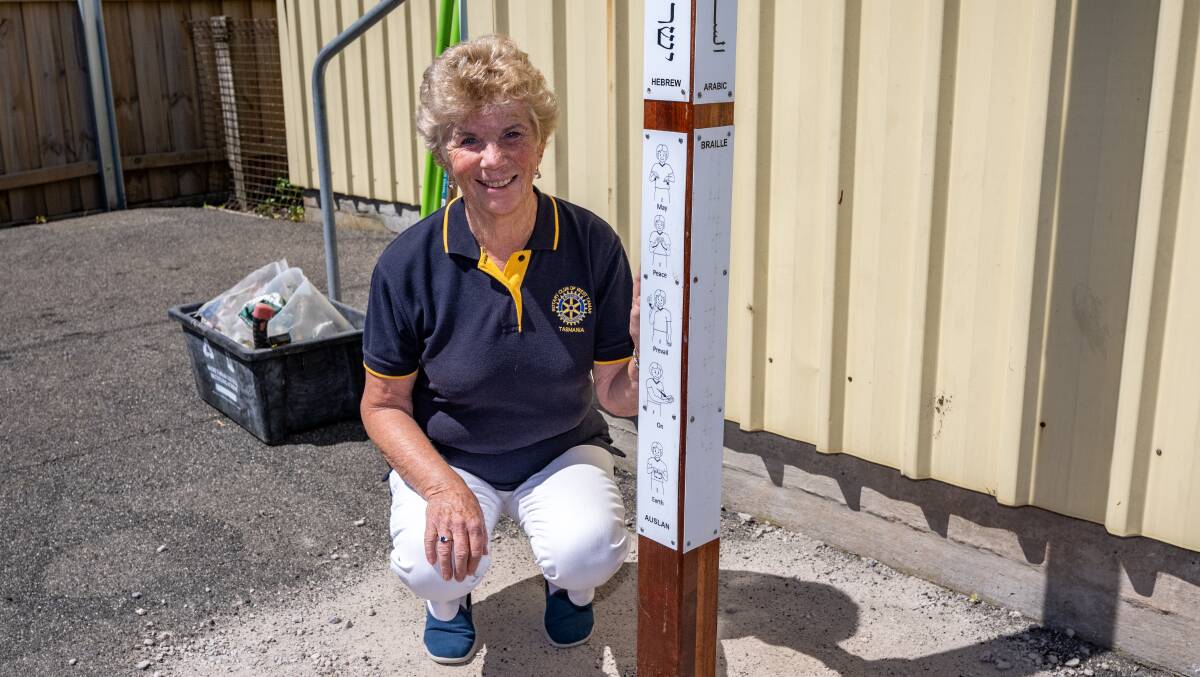 Rotary Peace Pole featuring Auslan and braille alongside Kathryn Darlow of the Rotary Club of West Tamar. Picture by Paul Scambler