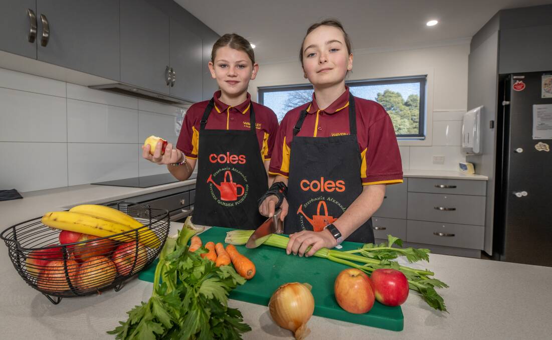 Waverley Primary School students Kacie Merriman and Charlotte Masters preparing food for the School Lunch Program. Picture by Craig George