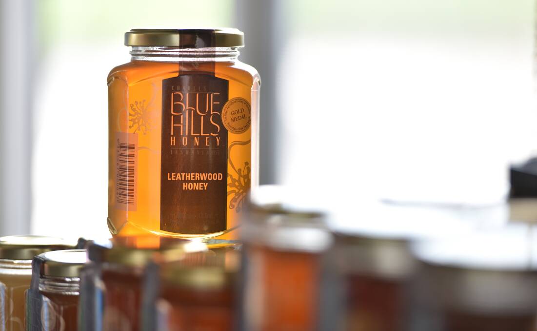 Gold medal winning leatherwood honey glows in the light at the Blue Hills Honey plant. Picture: Brodie Weeding