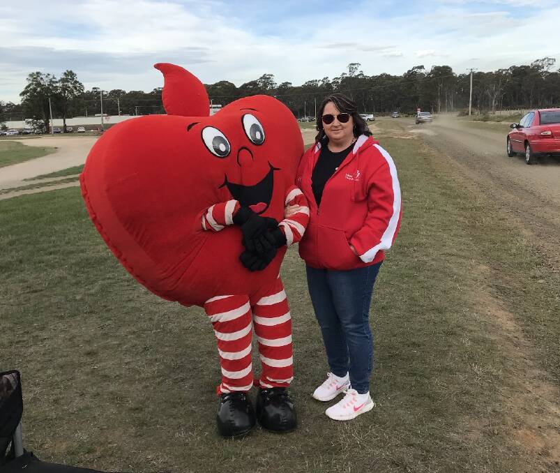 PEDAL TO THE METAL: Heart attack survivor and future demolition derby driver Leisa Fromberger with Heart Foundation mascot Happy Heart at Carrick Raceway. Picture: supplied