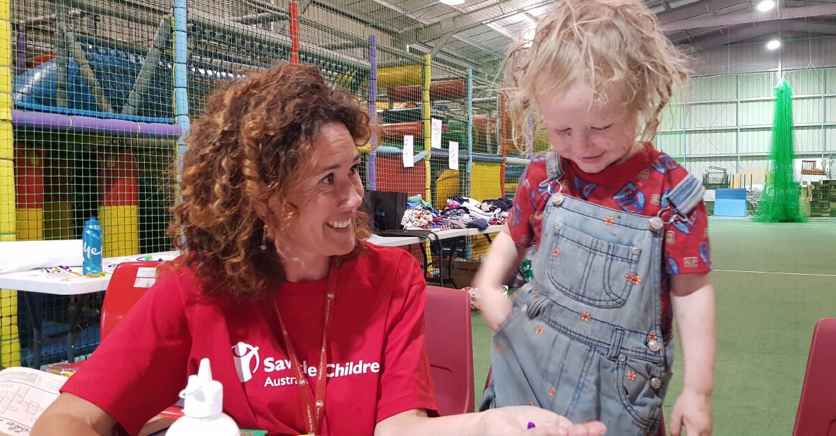 HELPING HAND: Youth worker Lucy Larby with Zubin, 3, at Save the Children’s child friendly space in Huonville. Zubin and his family evacuated from their home because of the bushfire threat. Photo credit: Simone Johns/Save the Children