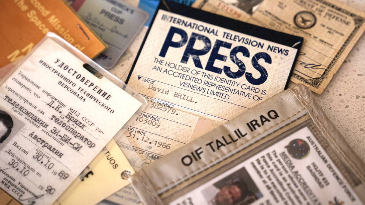 Brill has folders of press passes covering his 50-year career in the media.