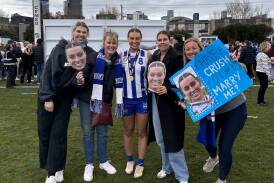 VFLW premiership player Jen Guy with her support crew following North Melbourne's win. Picture supplied
