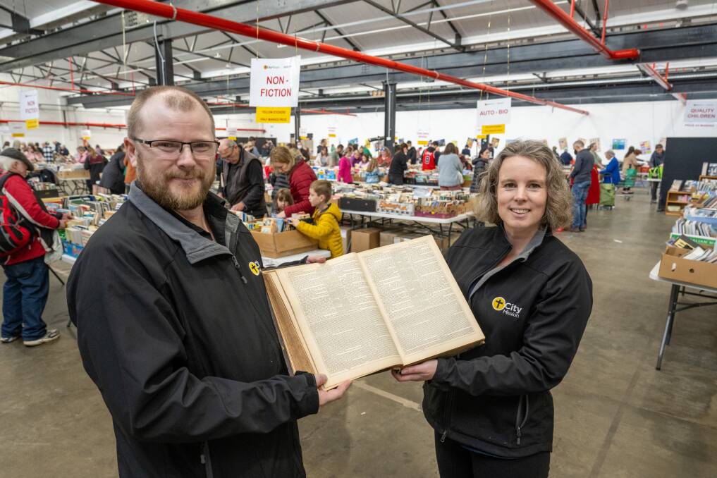 City Mission's Lee Pennington and Belinda Ratnik with the 1870 William Collins Sons & Co bible. Picture by Paul Scambler
