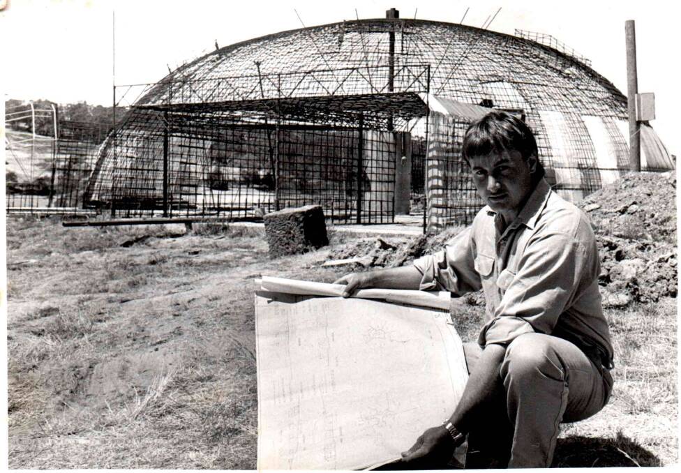 A young Kent Trickett shows off plans for his underground house. Picture supplied
