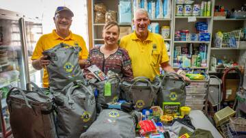 Riverside Lions Club duo Rod Peck and Brian Dunham and Shekinah House co-ordinator Louise Cowan. The club donated 50 backpacks for newly homeless people in Launceston. Picture by Paul Scambler