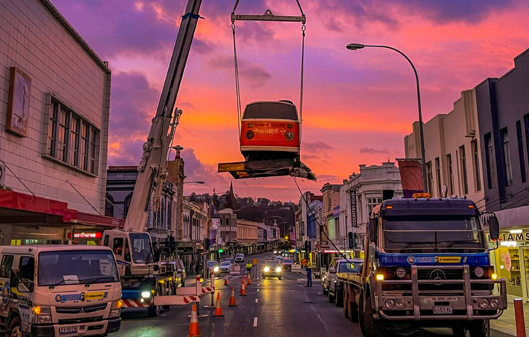 A crane lifts the Red Herring Kombi van onto a truck. Picture supplied/ Aaron Page 