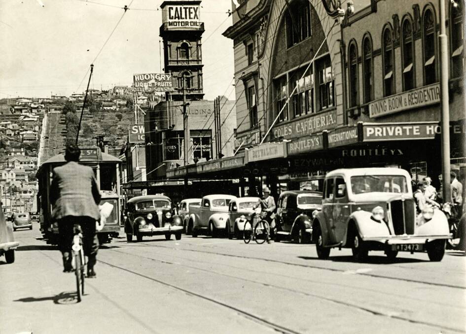 The Brisbane Street belltower became a well-known landmark in Launceston. Seen here around 1940 carrying advertising for Caltex. Air raid sirens were installed the following year. Picture by Launceston Library, LPIC147-6-322.