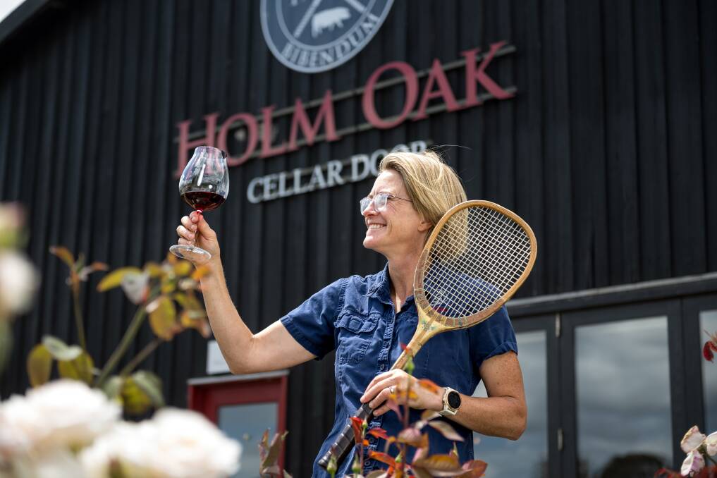 Holm Oak owner Bec Duffy shows off an Alexander racquet and a glass of red. Picture by Phillip Biggs