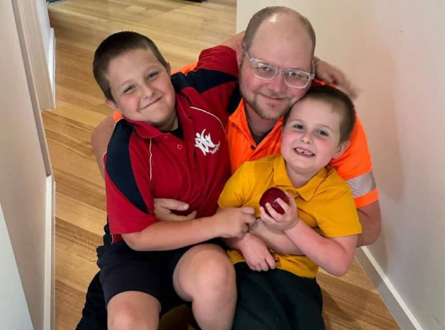 Launceston father Jaron Carney, pictured with his two sons, pays $800 in school fees for his four primary-school aged children. Picture: Supplied