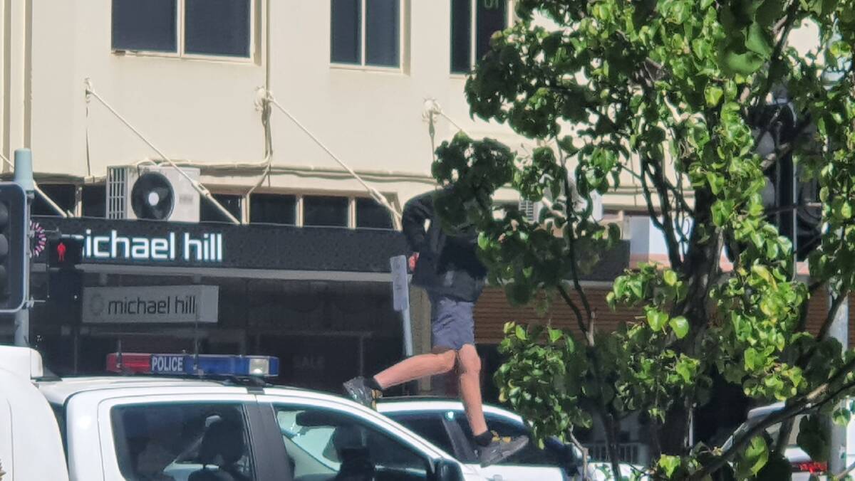 Alleged juvenile offender decides it time to get off top of police divisional van
