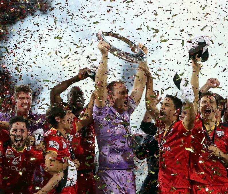 MOMENT IN TIME: A-League champions Adelaide United jubilantly hold up the revered silverware last month for the first time in its history during the 2015/16 grand final win over Western Sydney Wanderers. Picture: Getty Images