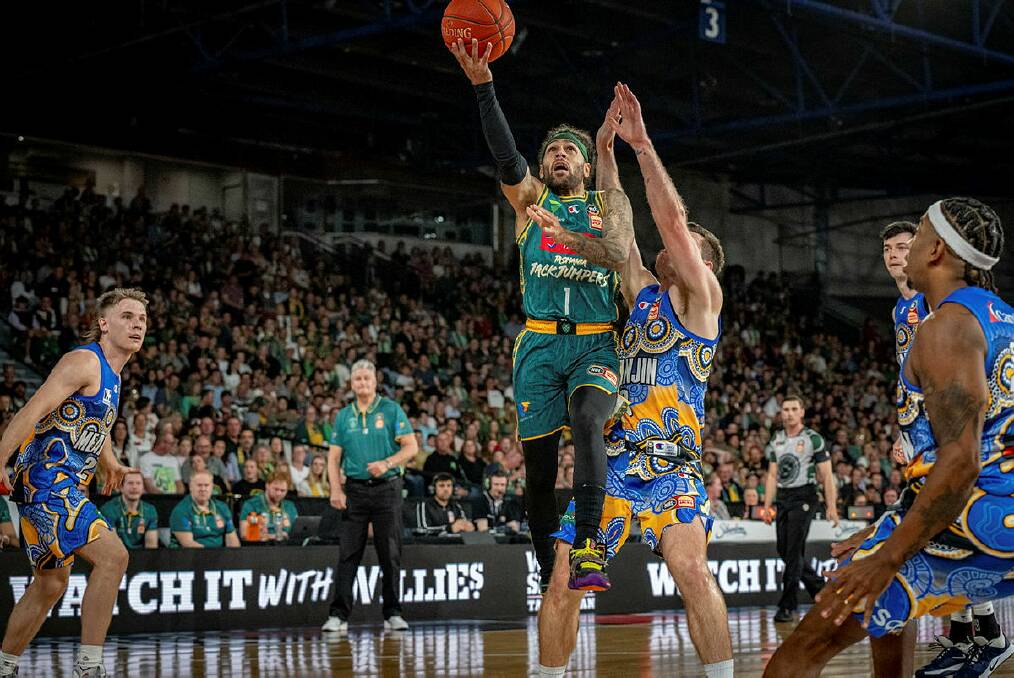 Tasmania JackJumpers' Jordon Crawford flies to the hoop during a 2023 game against Brisbane Bullets at the Silverdome. Picture by Paul Scambler 