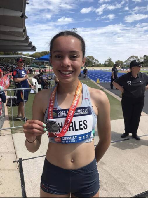 Chanel Charles with her under-14 girls' 400m silver medal. 