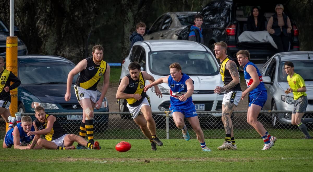 South Launceston's Will Harper and Rocherlea's Braydon Bassett chase the ball at Youngtown Oval.