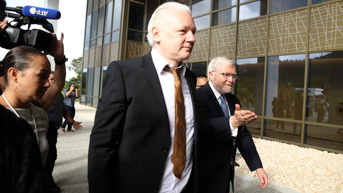 Julian Assange and US ambassador Kevin Rudd outside the Saipan court. Picture Getty Images